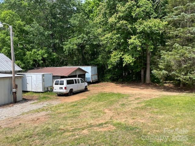 view of yard featuring an outdoor structure and a shed