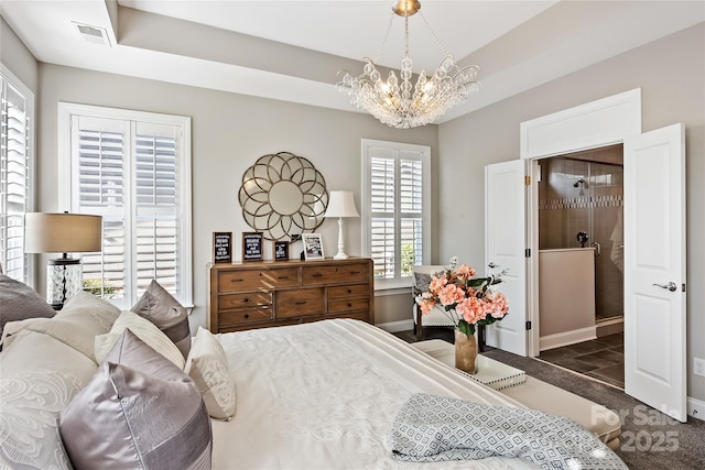 carpeted bedroom with baseboards, a chandelier, and visible vents