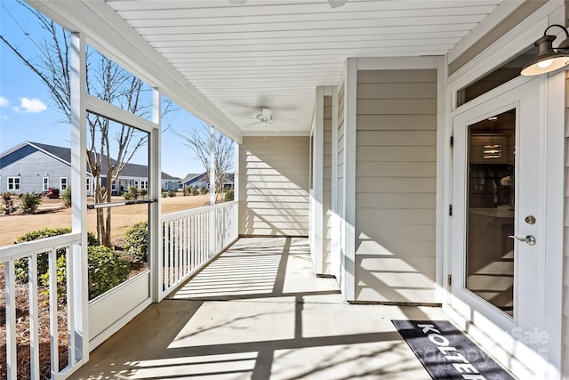 exterior space with a residential view, a ceiling fan, and a porch