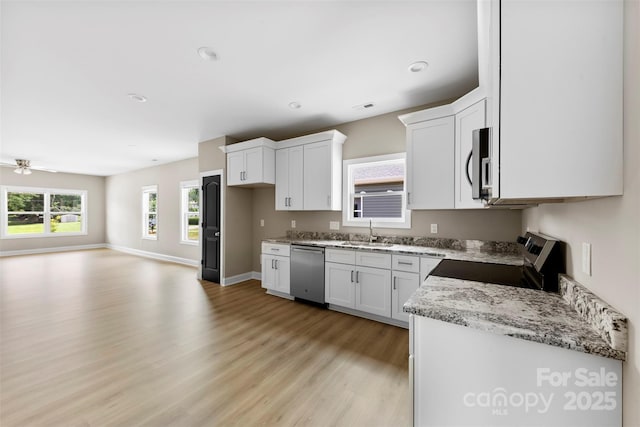 213 Benfield Rd, Kings Mountain, NC 28086 - kitchen with stainless steel appliances, light wood-type flooring, white cabinets, and recessed lighting