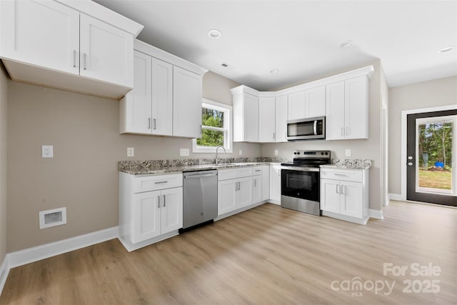 213 Benfield Rd, Kings Mountain, NC 28086 - kitchen with stainless steel appliances, light wood finished floors, light stone counters, white cabinets, and recessed lighting