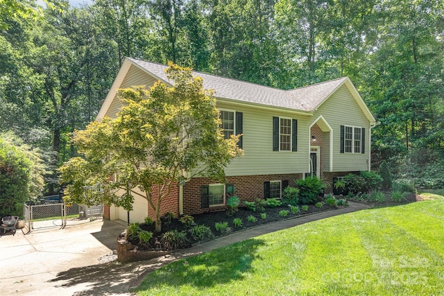 4700 Hickory Grove Rd, Mount Holly, NC 28120 - split foyer home with concrete driveway, an attached garage, and brick siding