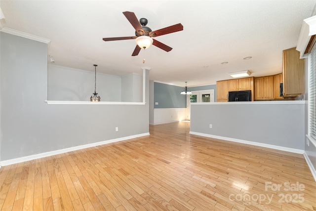 4700 Hickory Grove Rd, Mount Holly, NC 28120 - unfurnished living room with a ceiling fan, crown molding, a chandelier, light wood-style floors, and baseboards