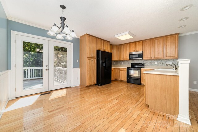 4700 Hickory Grove Rd, Mount Holly, NC 28120 - kitchen featuring black appliances, light wood finished floors, light countertops, a chandelier, and crown molding