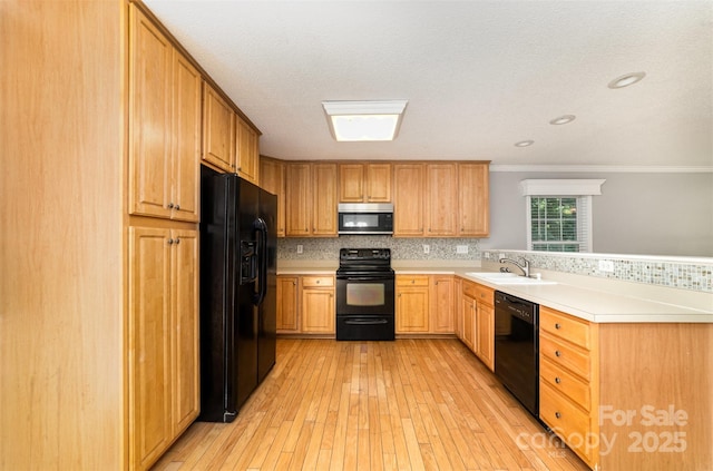 4700 Hickory Grove Rd, Mount Holly, NC 28120 - kitchen with black appliances, a sink, a peninsula, light countertops, and light wood-type flooring