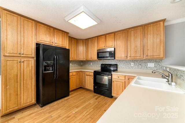 4700 Hickory Grove Rd, Mount Holly, NC 28120 - kitchen with black appliances, a sink, light countertops, light wood finished floors, and ornamental molding