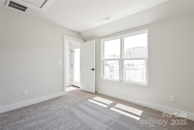 2013 Clarksdale Dr Unit 38, Charlotte, NC 28206 - carpeted empty room featuring baseboards and vaulted ceiling