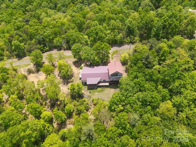 bird's eye view featuring a wooded view