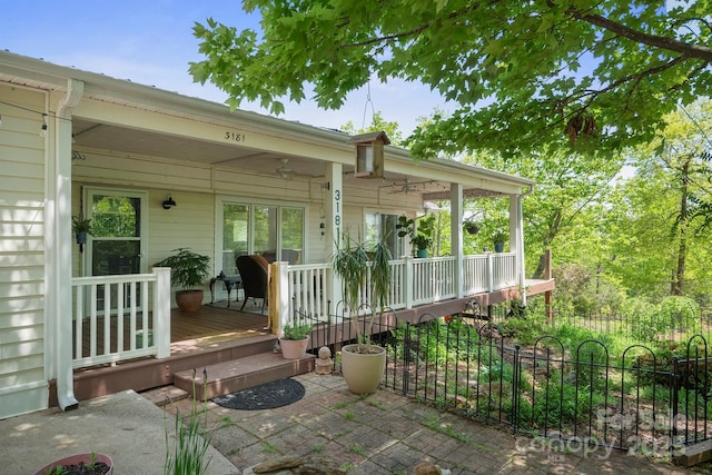 view of patio / terrace with a porch and fence