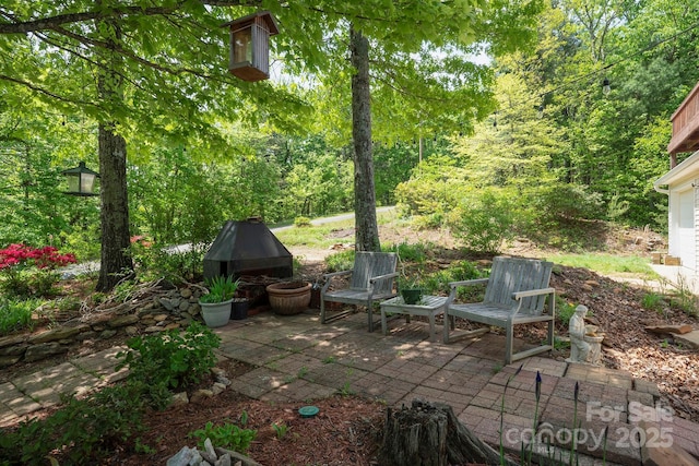 view of patio / terrace featuring a wooded view