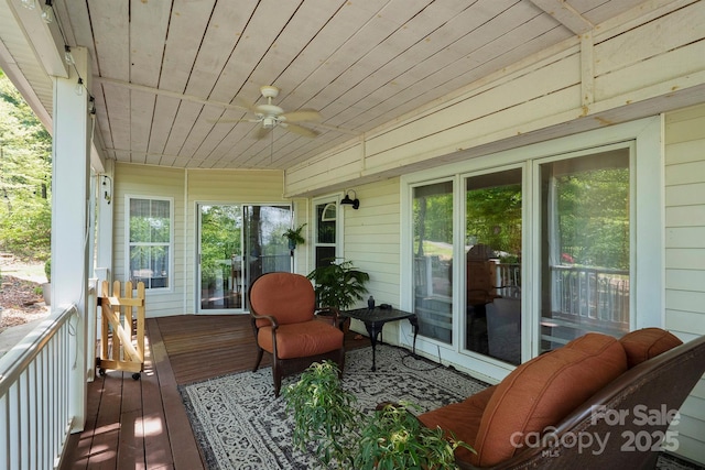 sunroom / solarium featuring ceiling fan and plenty of natural light