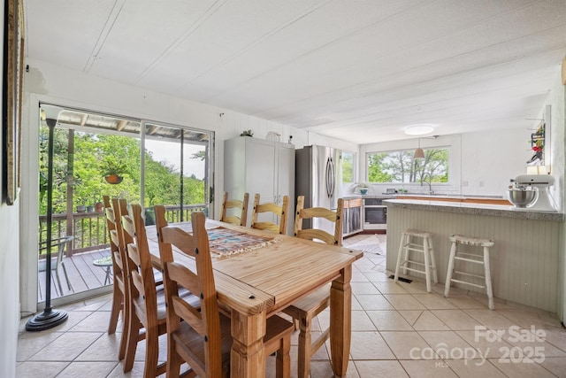dining space featuring light tile patterned floors