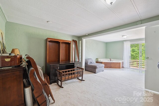 carpeted bedroom featuring access to outside and a textured ceiling