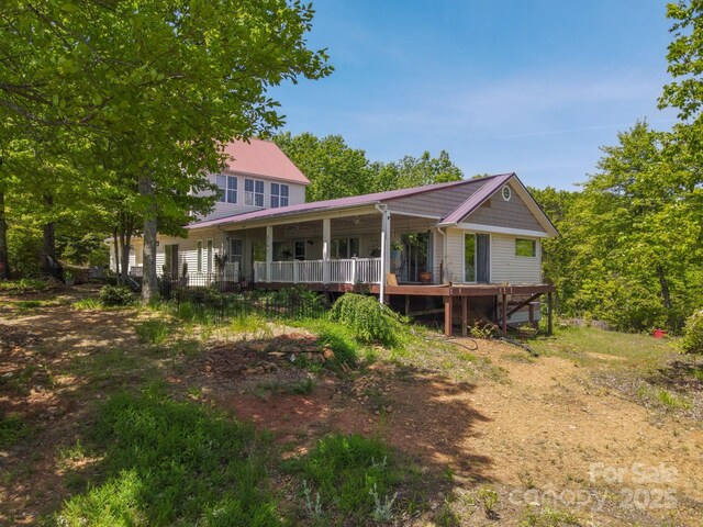 rear view of property featuring metal roof