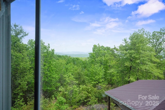 view of mountain feature featuring a forest view