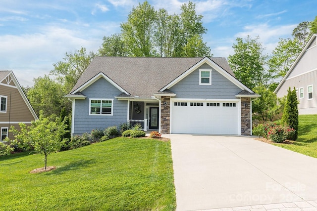 craftsman house with a garage, a front yard, and concrete driveway