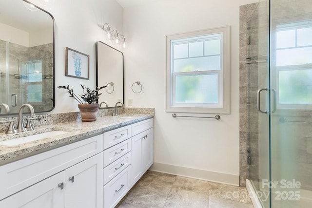 full bathroom featuring a sink, a shower stall, and a healthy amount of sunlight