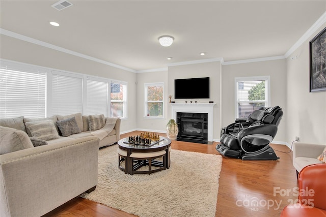 282 Fischer Rd, Fort Mill, SC 29175 - living room with crown molding, wood finished floors, a fireplace with flush hearth, recessed lighting, and baseboards