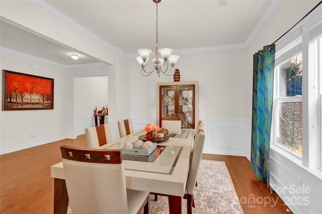 282 Fischer Rd, Fort Mill, SC 29175 - dining room with a chandelier, crown molding, wood finished floors, and wainscoting