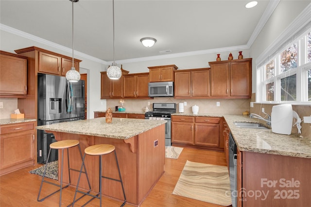 282 Fischer Rd, Fort Mill, SC 29175 - kitchen with stainless steel appliances, a kitchen island, brown cabinets, and crown molding