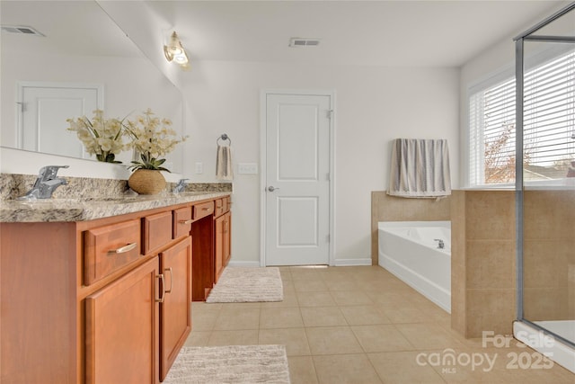 282 Fischer Rd, Fort Mill, SC 29175 - full bath featuring tile patterned flooring, double vanity, a bath, a shower stall, and baseboards