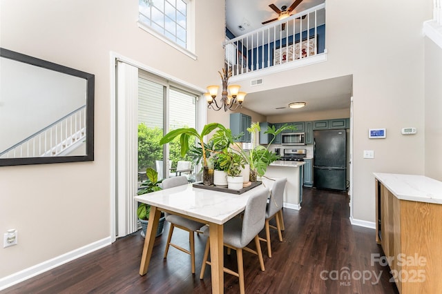 dining area with a healthy amount of sunlight, a high ceiling, and dark wood-style floors