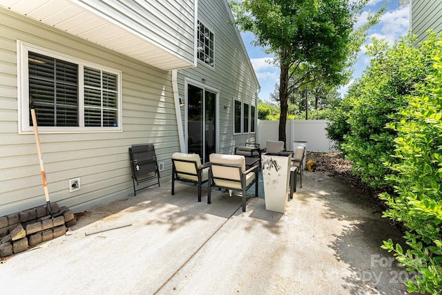 view of patio / terrace featuring fence
