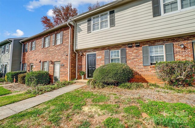 view of property featuring brick siding