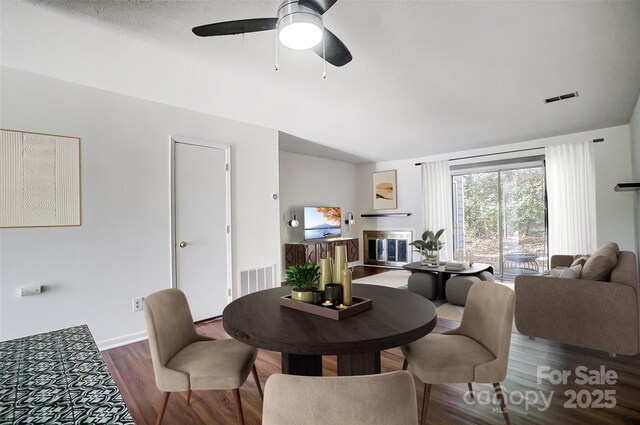 dining room with wood finished floors and a ceiling fan