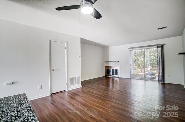 unfurnished living room with wood finished floors, ceiling fan, a glass covered fireplace, and baseboards