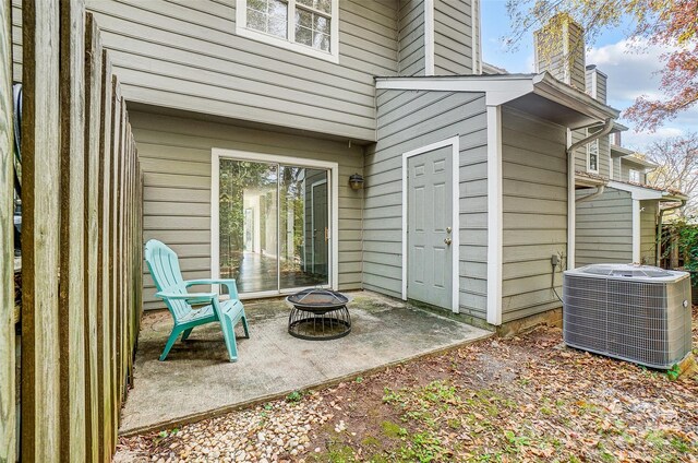 view of patio / terrace featuring a fire pit and central AC unit