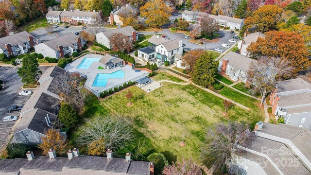 aerial perspective of suburban area featuring a pool