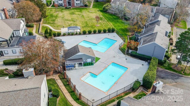 aerial perspective of suburban area featuring a pool area