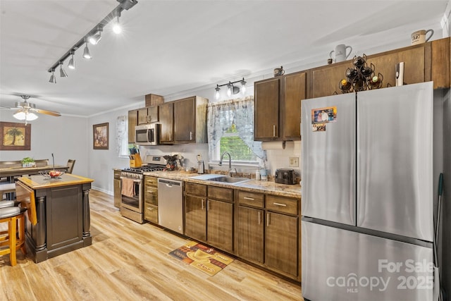 1792 Hoffman Rd, Gastonia, NC 28054 - kitchen with appliances with stainless steel finishes, a sink, light wood-style floors, light countertops, and track lighting