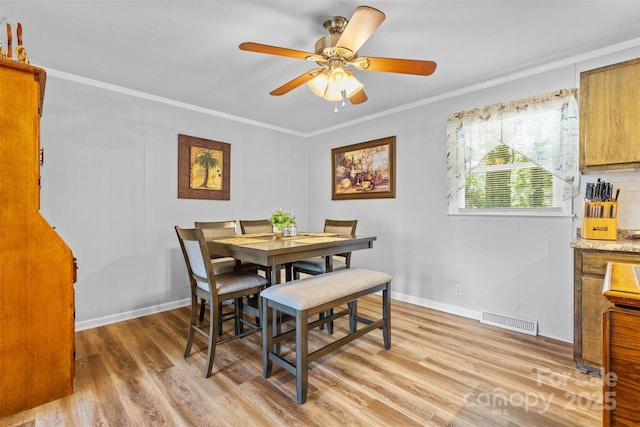 1792 Hoffman Rd, Gastonia, NC 28054 - dining space featuring light wood finished floors, crown molding, baseboards, and a ceiling fan