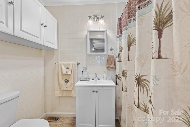 1792 Hoffman Rd, Gastonia, NC 28054 - bathroom featuring tile walls, toilet, vanity, tile patterned flooring, and ornamental molding