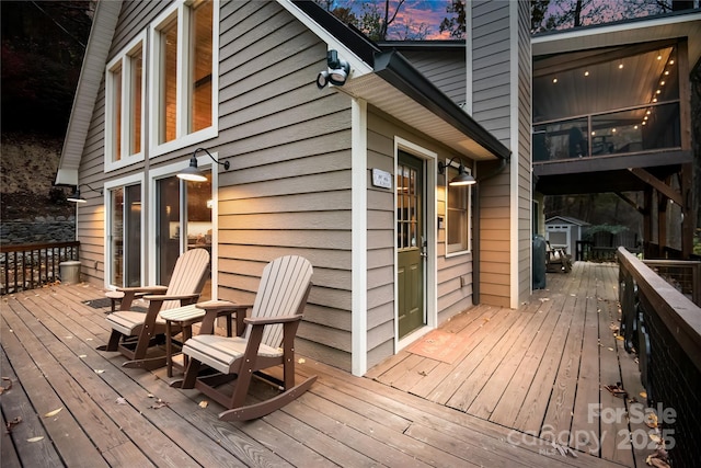 wooden deck featuring a shed