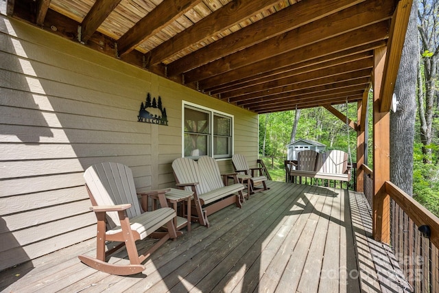 wooden deck featuring an outdoor structure and a storage shed