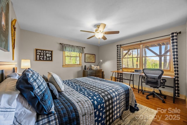 bedroom with ceiling fan and wood finished floors