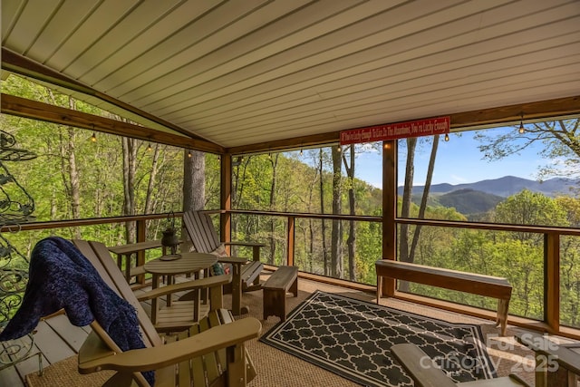 sunroom / solarium featuring a mountain view