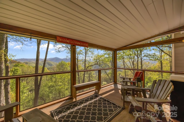 sunroom featuring a mountain view and plenty of natural light