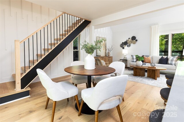 dining area with stairway and light wood-type flooring