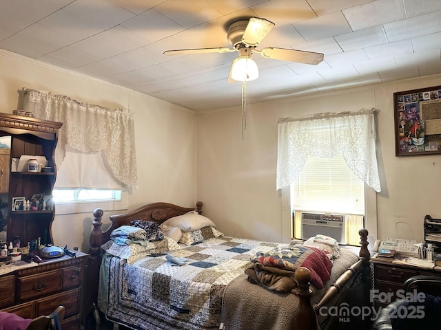 bedroom with ornamental molding and ceiling fan