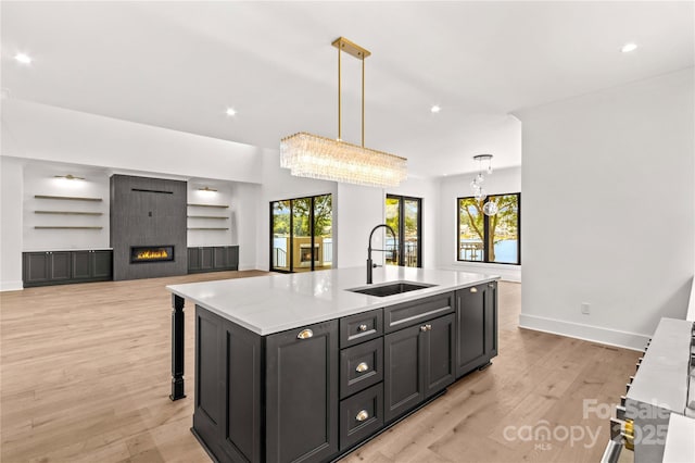 242 Shoreline Loop, Mooresville, NC 28117 - kitchen with built in shelves, recessed lighting, a center island with sink, light wood-style floors, and hanging light fixtures