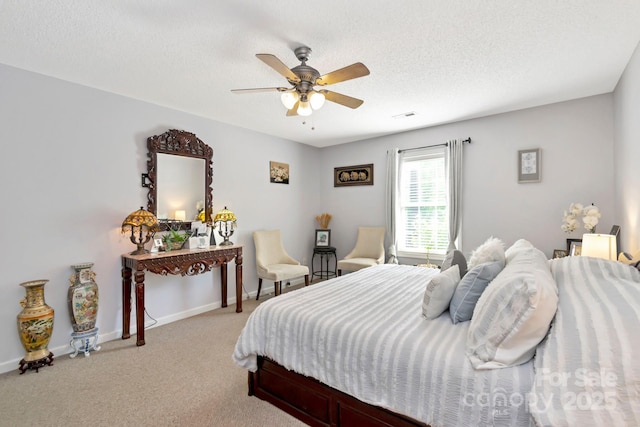 bedroom featuring baseboards, ceiling fan, light carpet, and a textured ceiling