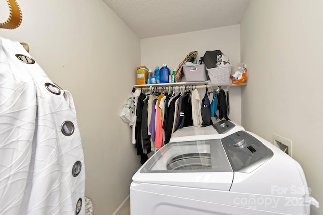washroom with laundry area, washer and clothes dryer, and baseboards