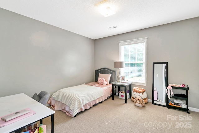 carpeted bedroom with visible vents and baseboards