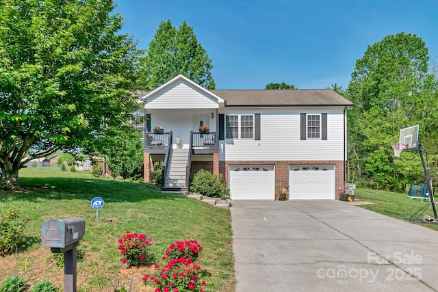 view of front of property with concrete driveway, an attached garage, stairs, and a front yard