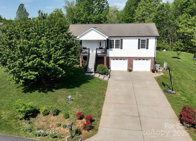 view of front of property featuring driveway, brick siding, a front lawn, an attached garage, and stairs