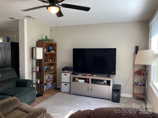 living area with a ceiling fan, baseboards, visible vents, and light wood-style flooring